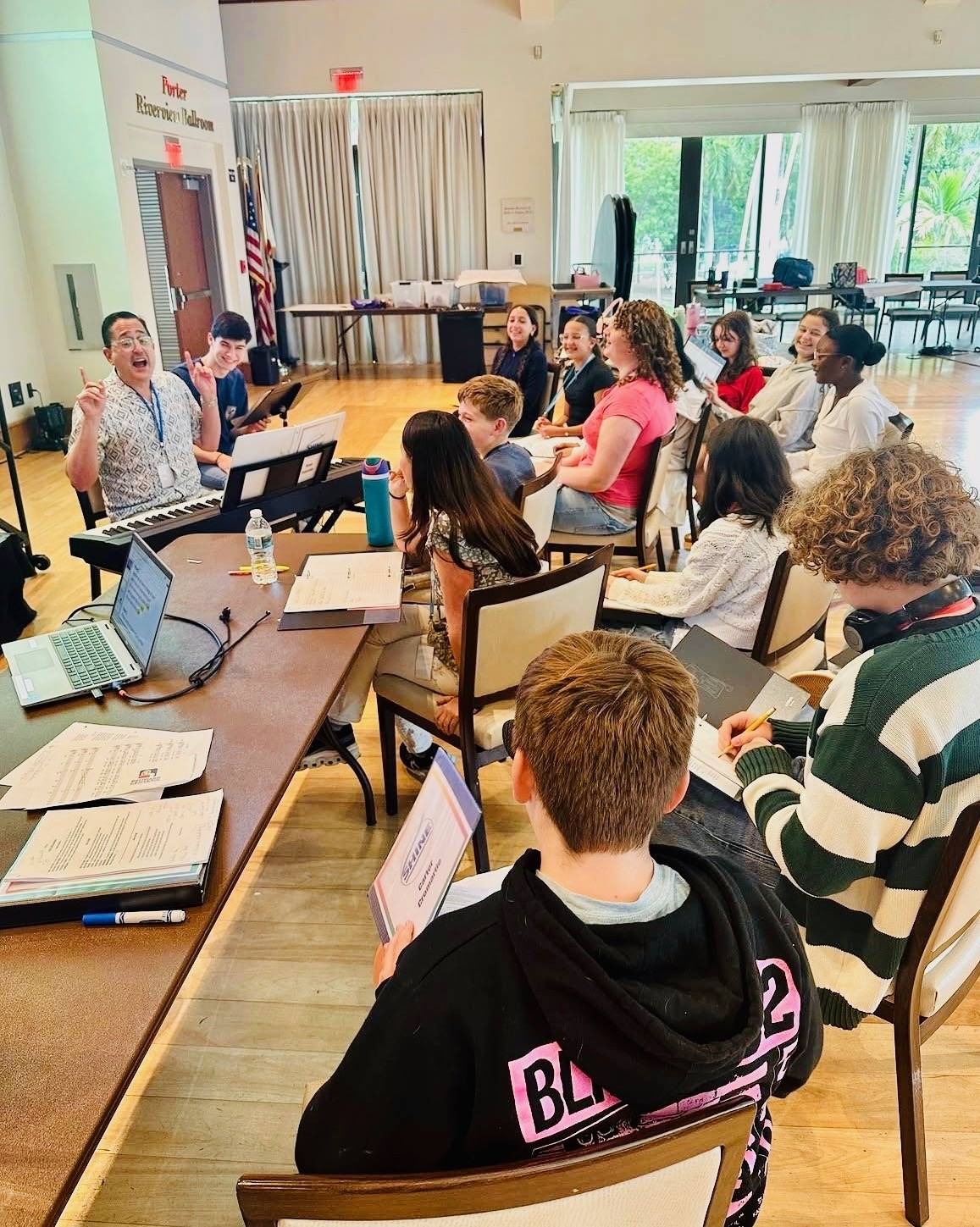 Brian leading a songwriting session at the piano