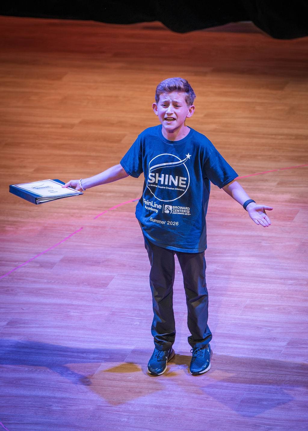 A young performer on stage on opening night