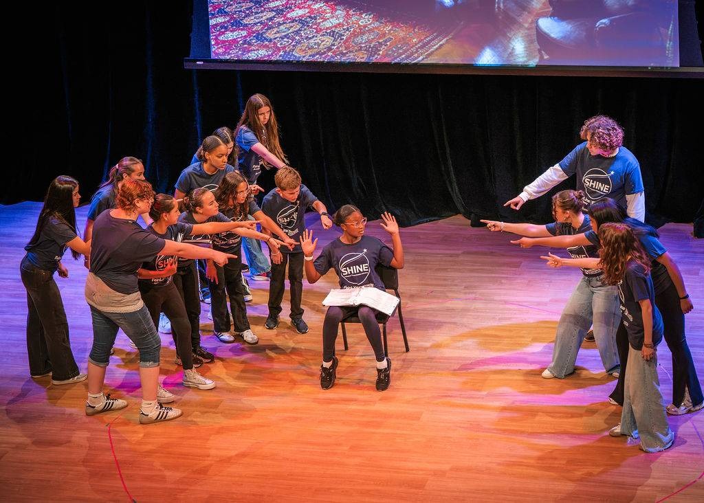 SHINE ensemble in a dramatic final pose on the Broward Center stage